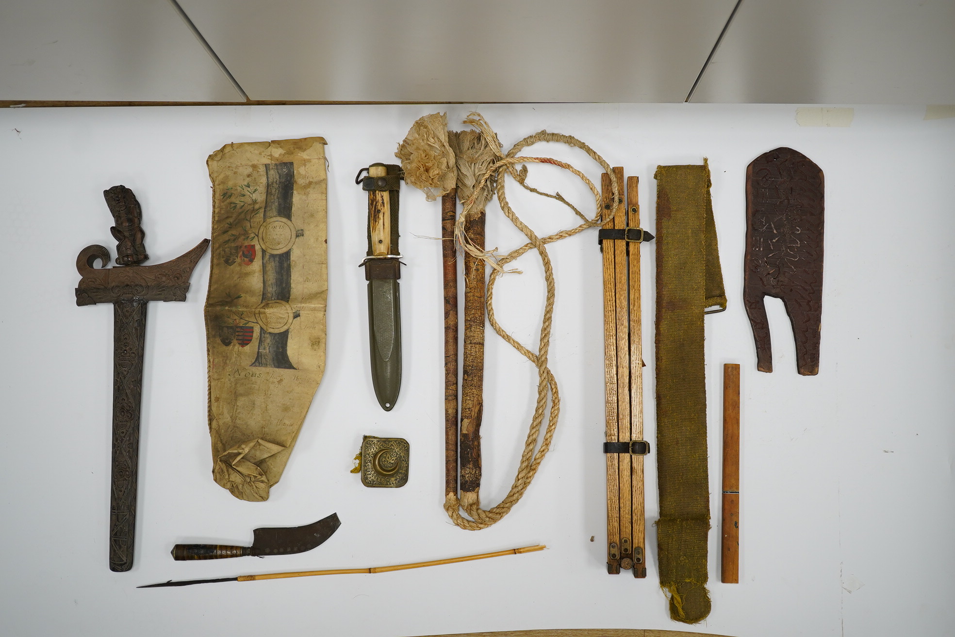 A section of a vellum family tree, converted into a bag, Together with an oak tripod, two whips, a Balanese Kris with lion man grip, a hunting dagger with horn grips, a small knife, etc. Condition - poor to fair